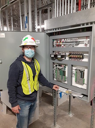 BSS Technician next to DDC Control Panel